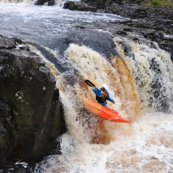 Connor Proud running a waterfall in a Spanish Fly open canoe