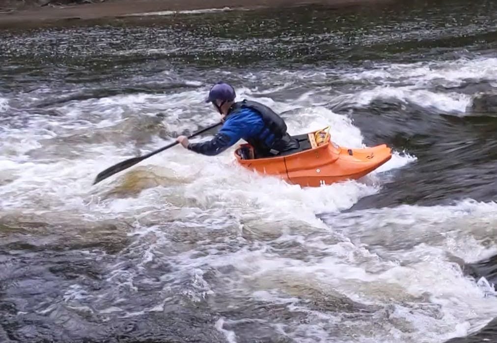 Daniel Cutter paddling OC1 on Bottom Wave at low water at Mile End Mill, Llangollen