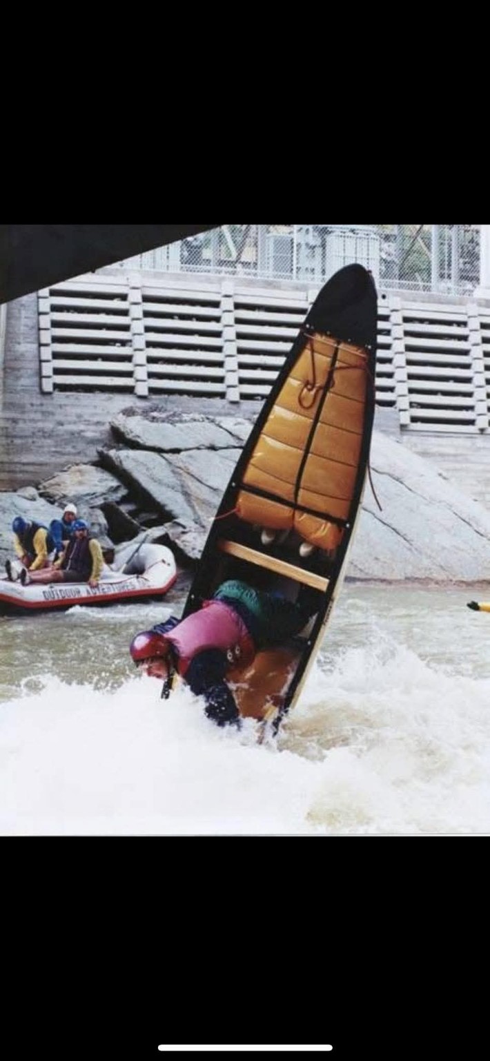 Old-school OC1 paddler performing an ender at Hell Hole on the Ocoee River